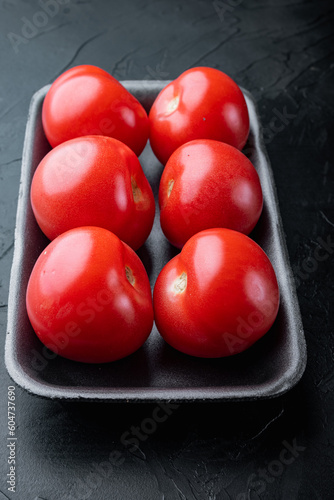 Fresh red organic tomatoe, on black background