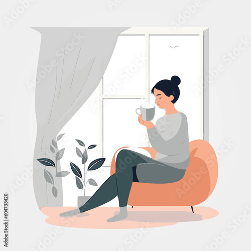 woman sitting on sofa in the morning drinking coffee