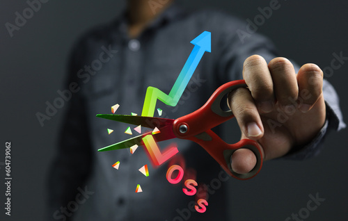 Stock market investor choose to use the stop loss method to saving costs or willing to sell losses before the price goes down much further. Scissors cutting graph 3D to broken for cut loss concept. photo