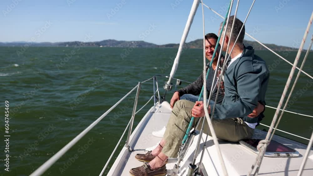 Loving gay LGBTQ male couple sailing together San Francisco Bay Loving gay LGBTQ male couple sailing together San Francisco Bay