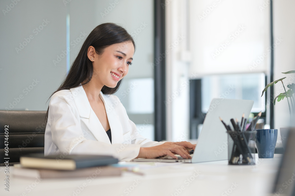 Image of successful businesswoman looking at laptop scree, satisfied with results of achievement at work. Image of successful businesswoman looking at laptop scree, satisfied with results of achievement at work.