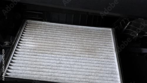 Closeup of old and dirty car air filter with dust in car. Concept of car care service maintenance and health.