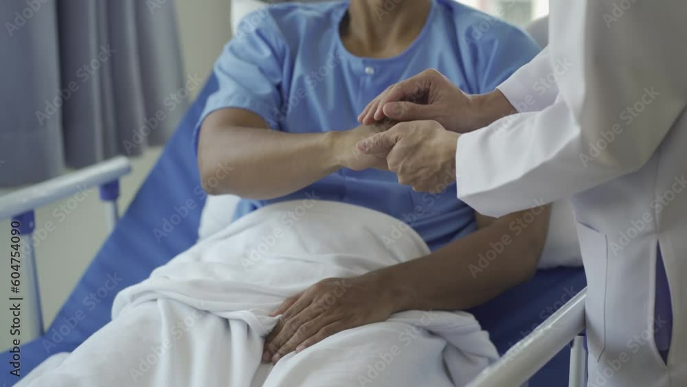 Happy doctor visiting young male patient to bring good news and encouragement in inpatient room encouraging patient to take care of health after discharge from hospital Happy doctor visiting young male patient to bring good news and encouragement in inpatient room encouraging patient to take care of health after discharge from hospital