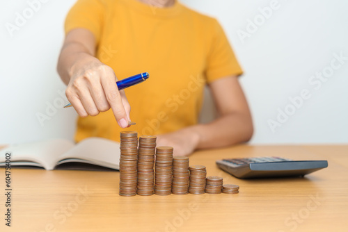 Money Saving for Future Plan, Retirement fund, Pension, Investment, Wealth Business and Financial concepts. Woman calculate and counting money coins on table
