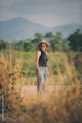 asian woman wearing straw hat standing outdoor toothy smiling with happiness face