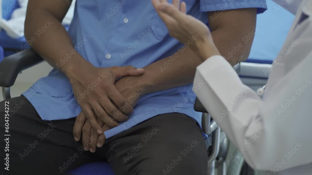 Happy doctor visiting young male patient to bring good news and encouragement in inpatient room encouraging patient to take care of health after discharge from hospital Happy doctor visiting young male patient to bring good news and encouragement in inpatient room encouraging patient to take care of health after discharge from hospital
