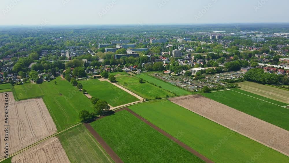 Aerial of beautiful green meadows at the edge of a small town in the Netherlands Aerial of beautiful green meadows at the edge of a small town in the Netherlands