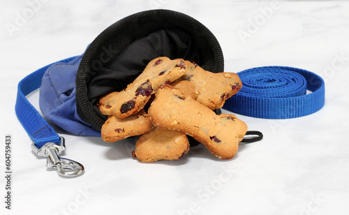 Cranberry dog cookies in a training bag with a leash.