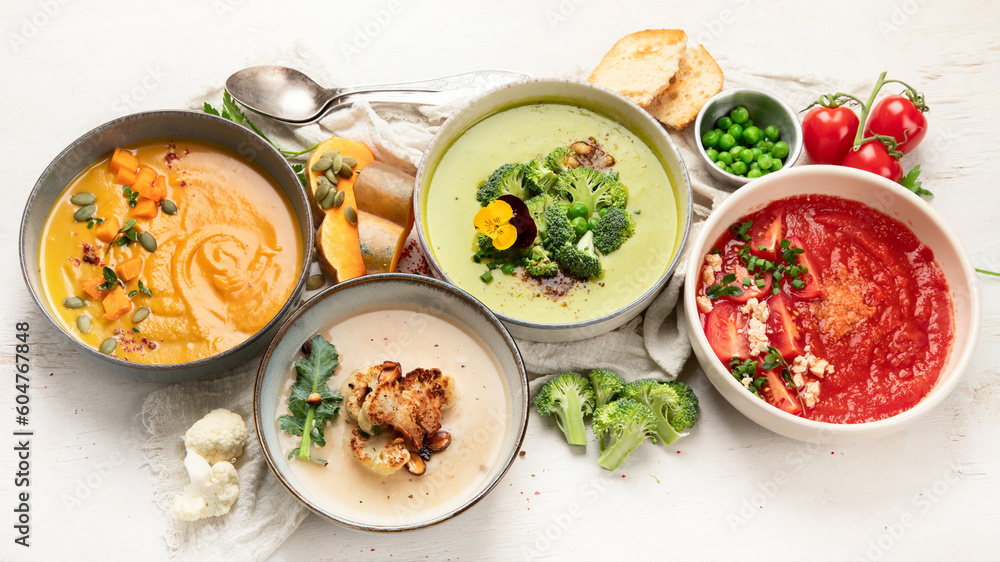 Composition with various soups, ingredients and space for text on white background. Healthy food. Composition with various soups, ingredients and space for text on white background. Healthy food.