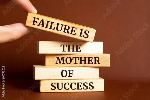 Wooden blocks with words 'Failure is the mother of success'.