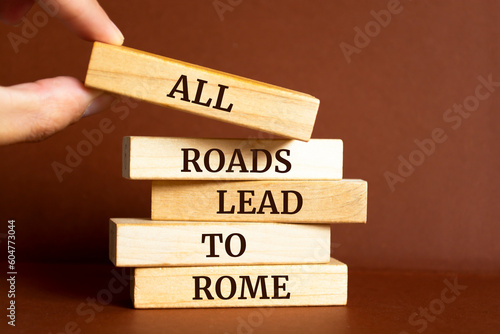 Photography Wooden blocks with words 'All roads lead to Rome'.