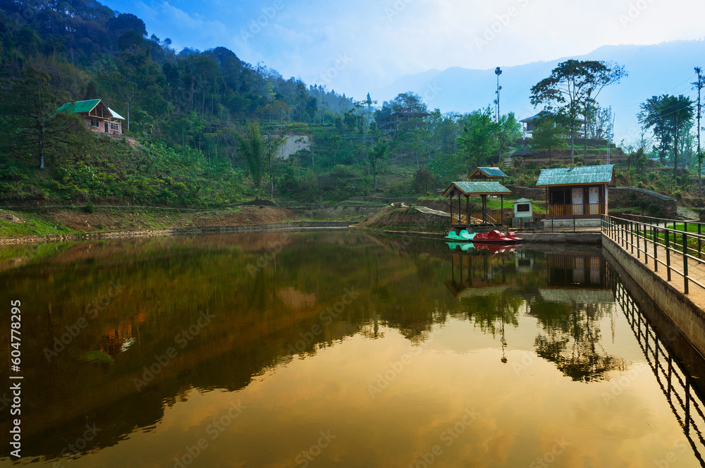 Fototapeta premium Boating spot of Chayatal or Chaya Taal, West Sikkim, India. Famous for Reflection of snow-capped Mount Kanchenjunga and Kabru on lake water, Himalayan mountains and forest surrounding.