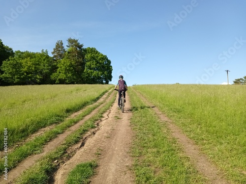 nature, sky, landscape, road, grass, summer, walking, field, mountain, park, green, people, woman, travel, tree, bike, hill, sport, outdoor, bicycle, outdoors, tourist, path, walk, hiking © Dominika