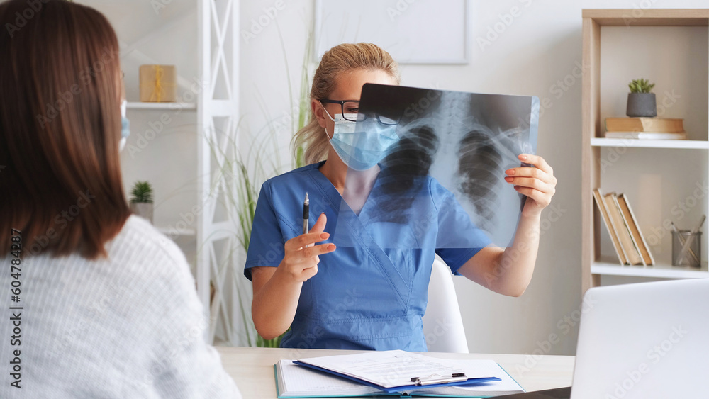 X-ray examination. Skeleton radiology. Woman doctor surgeon holding ...