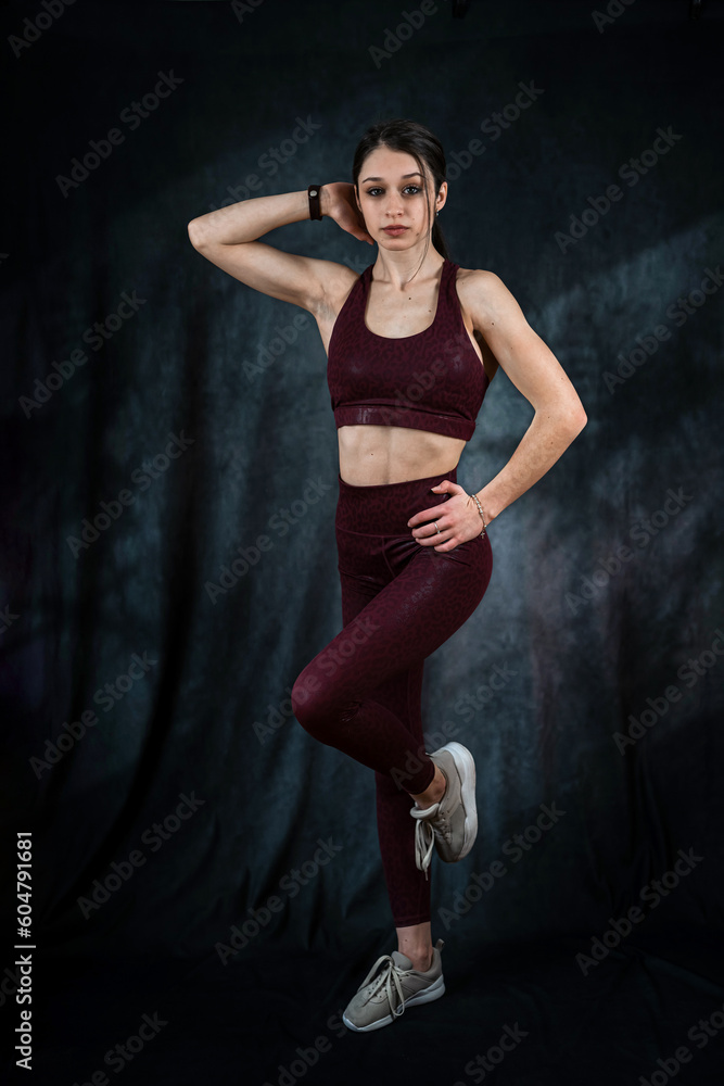 Portrait of happy beautiful fit woman in sport cloth isolated on black Portrait of happy beautiful fit woman in sport cloth isolated on black