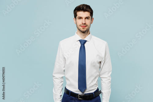 Young serious calm caucasian successful employee business man corporate lawyer wear classic formal shirt tie work in office look camera isolated on plain pastel light blue background studio portrait. photo