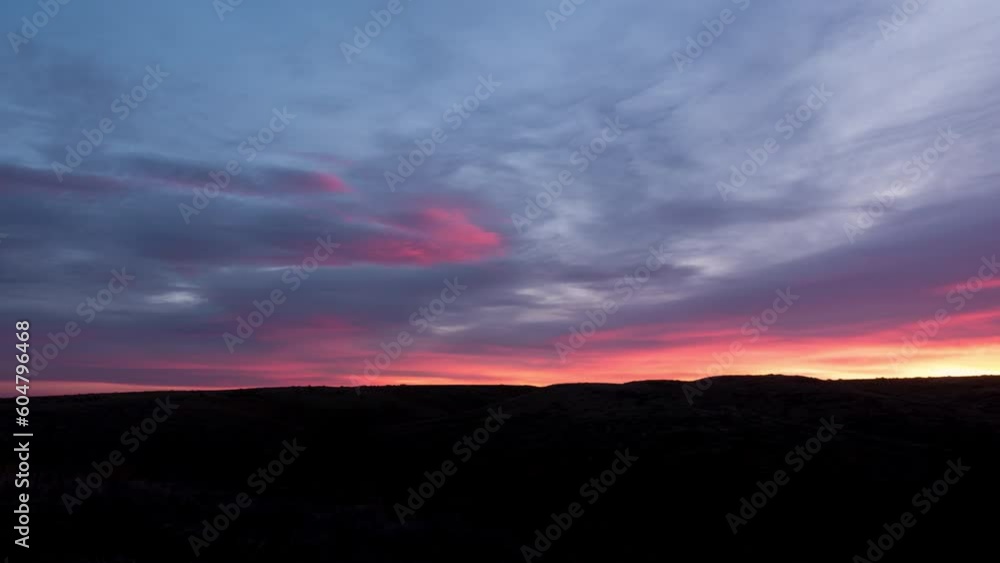 Time lapse over prairie valley as sun rise light on clouds Time lapse over prairie valley as sun rise light on clouds