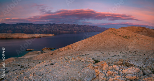 The rugged, rocky landscape of the island of Pag in Croatia shown during a beautiful sunset