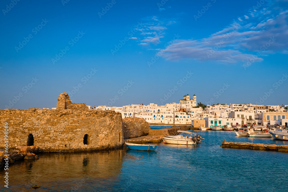 Greek whitewashed houses, old castle and church by harbour waterfront