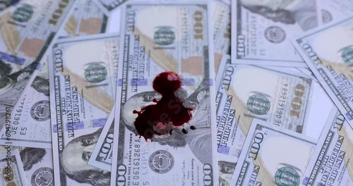 100 dollar bill with blood stains closeup. Blood money and crime photo