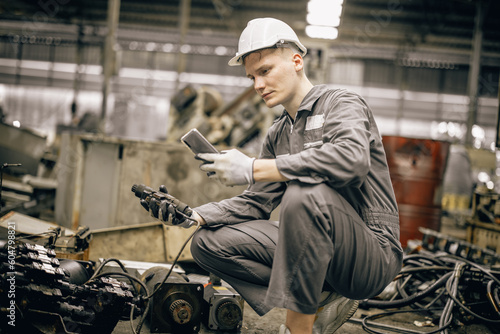 Engineering technicians use hand tools to perform regular maintenance by inspecting, testing, repairing machinery and engines to ensure they stay in standard condition. Identifying any malfunctions. © SpaceOak
