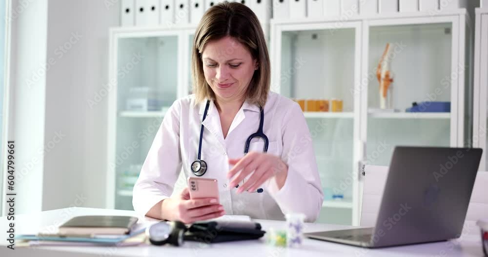 Therapist using mobile medical application consults remote patient online and telemedicine. Nurse woman holding smart phone for digital consultation