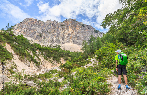 Obraz na płótnie A young tourist on his way to Špik admiring the Lipna špica ridge in the Julian Alps (Slovenia). w salonie