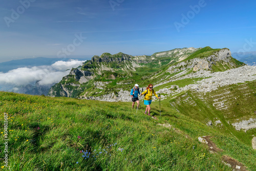 Italy, Province of Belluno, Pair of hikers following Alta Via Dolomiti Bellunesi trail photo