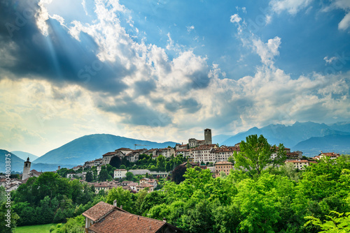 Italy, Veneto, Feltre, Clouds over town in Dolomites photo