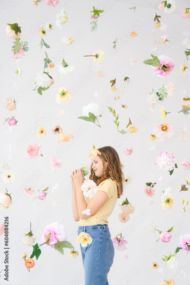 Smiling girl standing amidst falling flowers Smiling girl standing amidst falling flowers