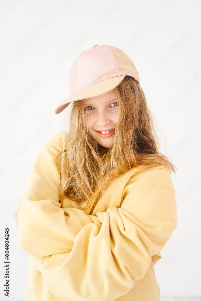 Smiling blond girl with arms crossed against white background Smiling blond girl with arms crossed against white background