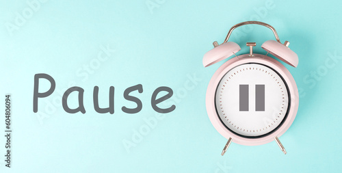 Alarm clock with pause sign, pastel color, time for a break, having lunch or a cup of coffee
 photo