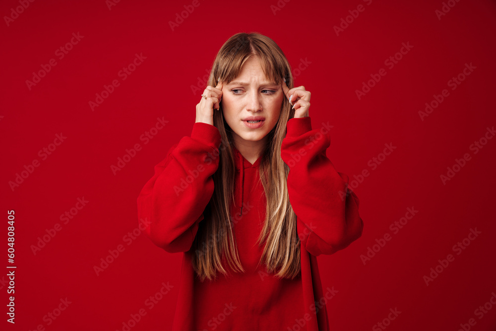 Young blonde woman with headache rubbing her temples Young blonde woman with headache rubbing her temples