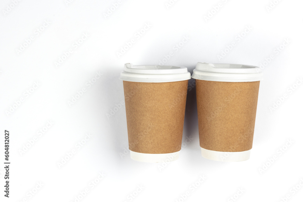 Paper disposable cups on a white background, flat lay. Paper disposable cups on a white background, flat lay.