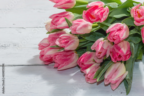 Fototapeta Naklejka Na Ścianę i Meble -  Bouquet of fresh pink tulips on white wooden background. Festive concept for Mother's Day