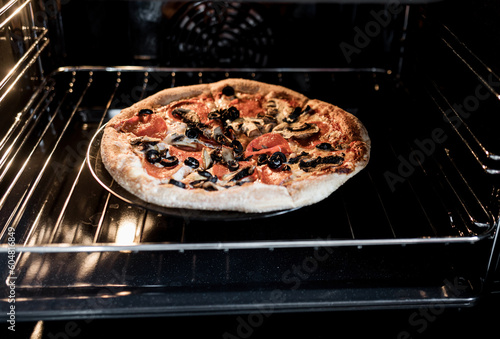 homemade pizza with pepperoni, mushrooms, olives