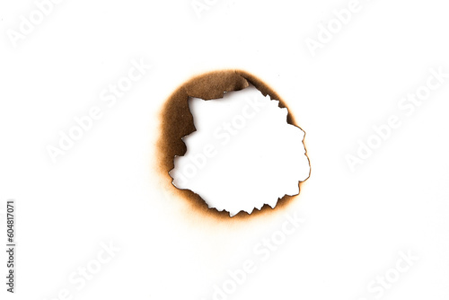 burnt holes in a piece of paper isolated on white background