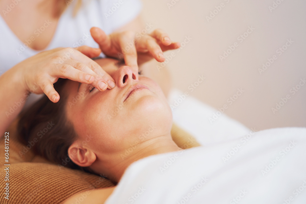 Woman having japan style face massage in salon Woman having japan style face massage in salon