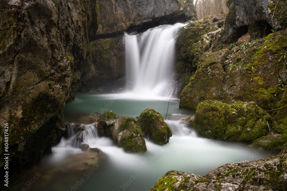 Obraz premium Waterfall with mossy rocks in mountain canyon in long exposure, Svrakava waterfall near Banja Luka