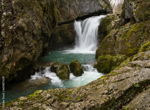 Waterfall with mossy rocks in mountain canyon  Svrakava waterfall near Banja Luka
