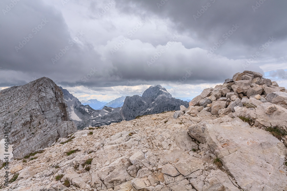 On the top of Mala Mojstrovka (2332 m) in the Julian Alps (Slovenia) on a cloudy summer day. In the background Jalovec (2643 m).