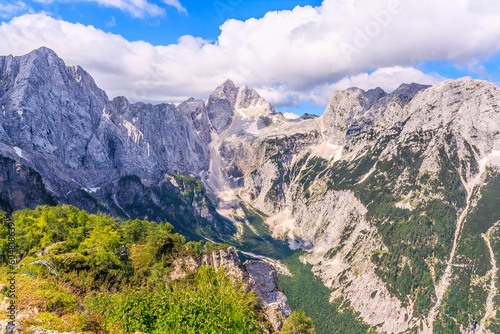 View from Slemenova špica (1911 m) in the Julian Alps (Slovenia) to the rock wall of the surrounding peaks. On the left one of the peaks of Mojstrovka, in the middle - Jalovec (2643 m). photo
