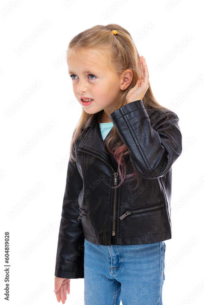 Portrait of irritated five year old girl with hand over ear listening an hearing to rumor or gossip isolated on white background. Blondy child in black leather jacket and blue jeans posing in studio. Portrait of irritated five year old girl with hand over ear listening an hearing to rumor or gossip isolated on white background. Blondy child in black leather jacket and blue jeans posing in studio.