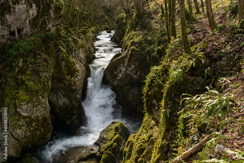 Waterfall with mossy rocks in mountain canyon  Svrakava river near Banja Luka
