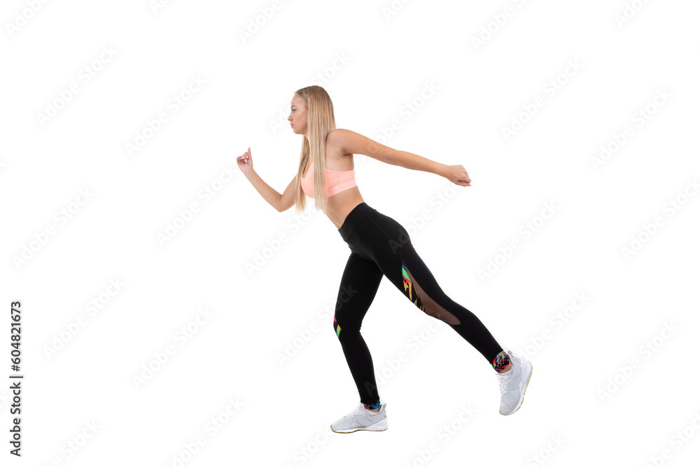 A sporty woman in a pink top, dark leggings and sneakers does exercises on a white background. Isolated...