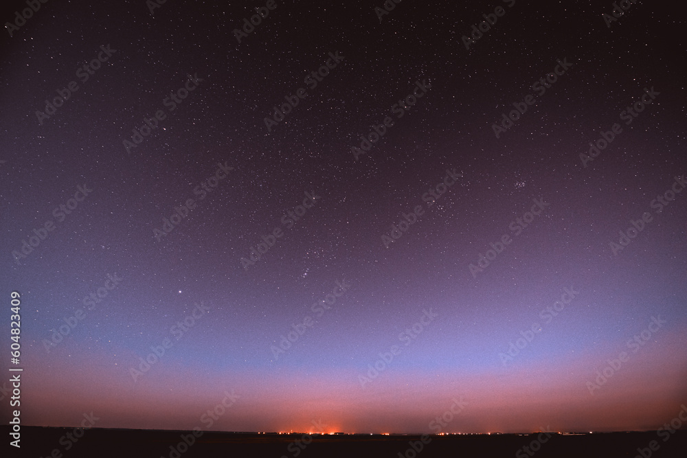 Fototapeta premium Night Violet Sky Glowing Stars Background Backdrop With Sky Gradient. Colorful Night Starry Sky In Blue Colors. Amazing Night View Sky Above Village. Concept Of Relax Music. Tranquility View.