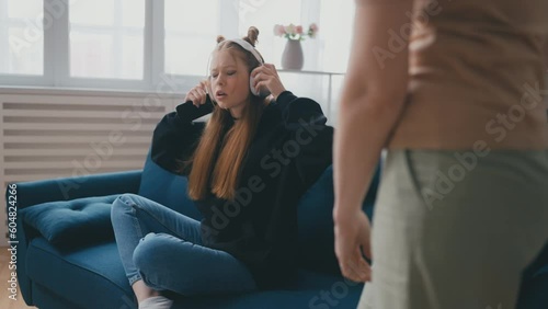 Rebellious teen daughter arguing with her mom, puberty, rude behavior, hormones photo