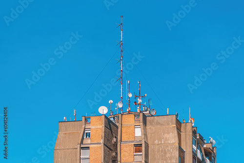 Communication antennas and satellite dishes on top of high residential building