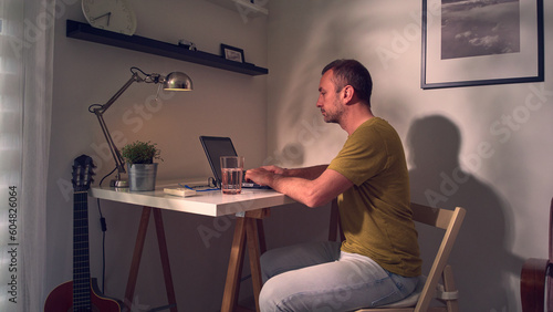 Man working on a laptop at home.