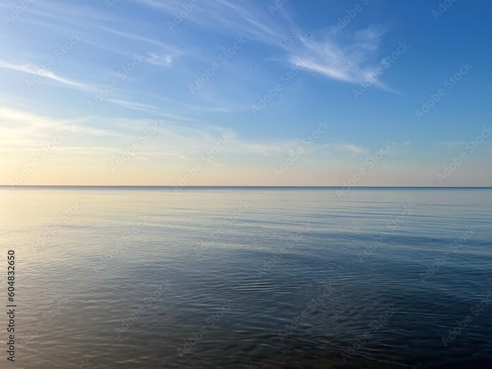 Blue sea horizon with some light clouds, seascape background Blue sea horizon with some light clouds, seascape background